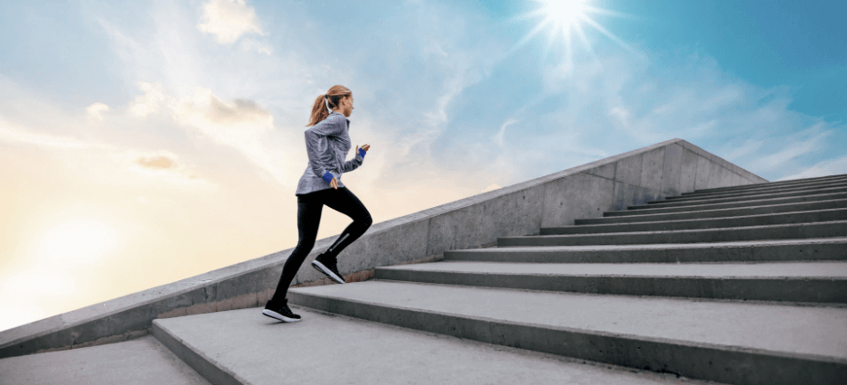 Sportlerin läuft eine Treppe rauf.