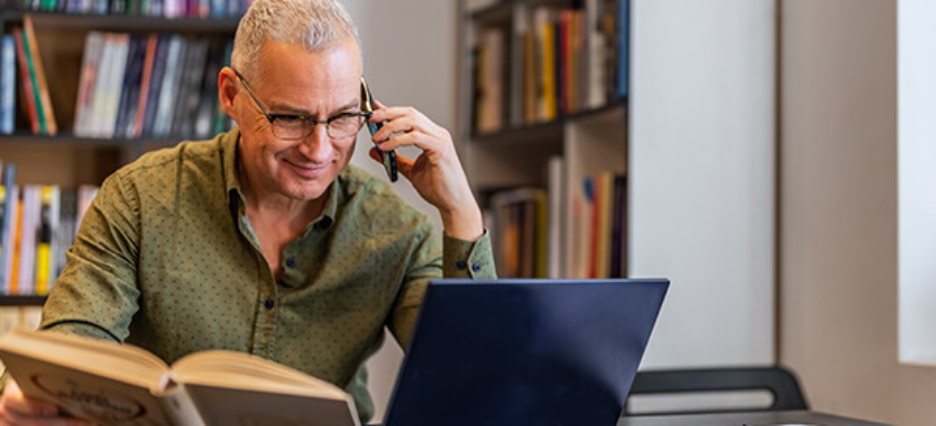 Schulleiter im Gespräch am Telefon.