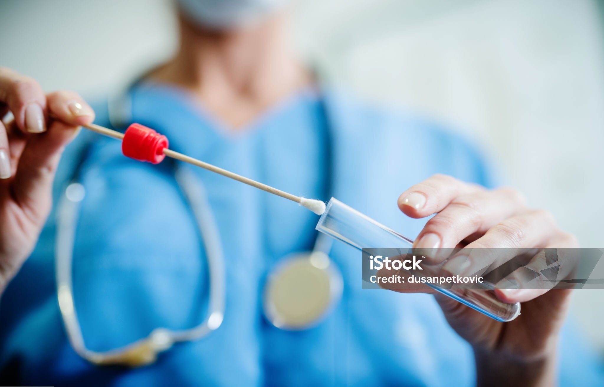 Close up of doctor with sample from sick woman. Selective focus on sample.